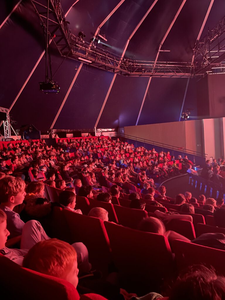 Publikum in einem vollen Zelt beim Event